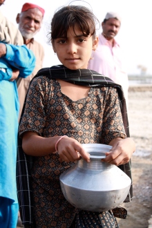 A young girl in Pakistan's Sindh province lines up for clean drinking water provided by UKaid. Image via Department for International Development.
