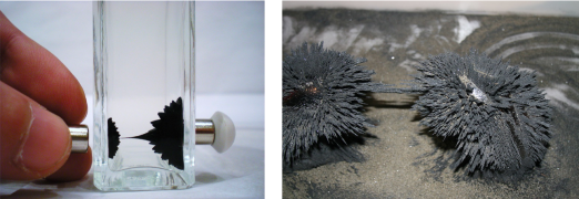 Left: black fluid in a har forms smooth, rounded peaks suspended between two magnets. Right: spiky gray iron filings form two mounds on a tan surface