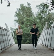 two people running on a bridge
